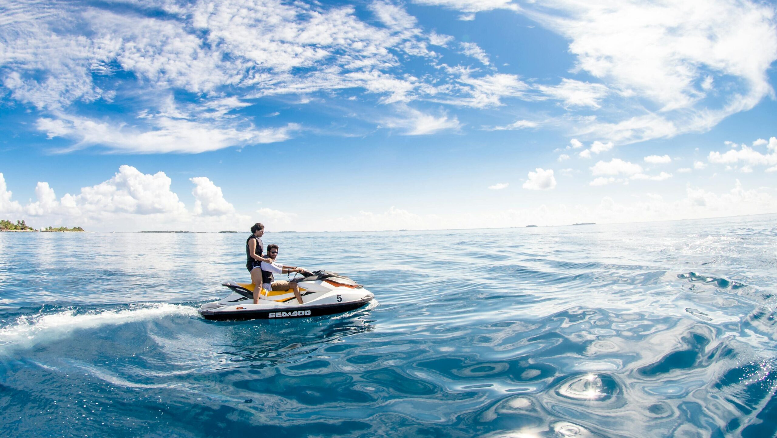 Enjoy a thrilling jet ski ride in the serene waters of Kaafu Atoll, Maldives.